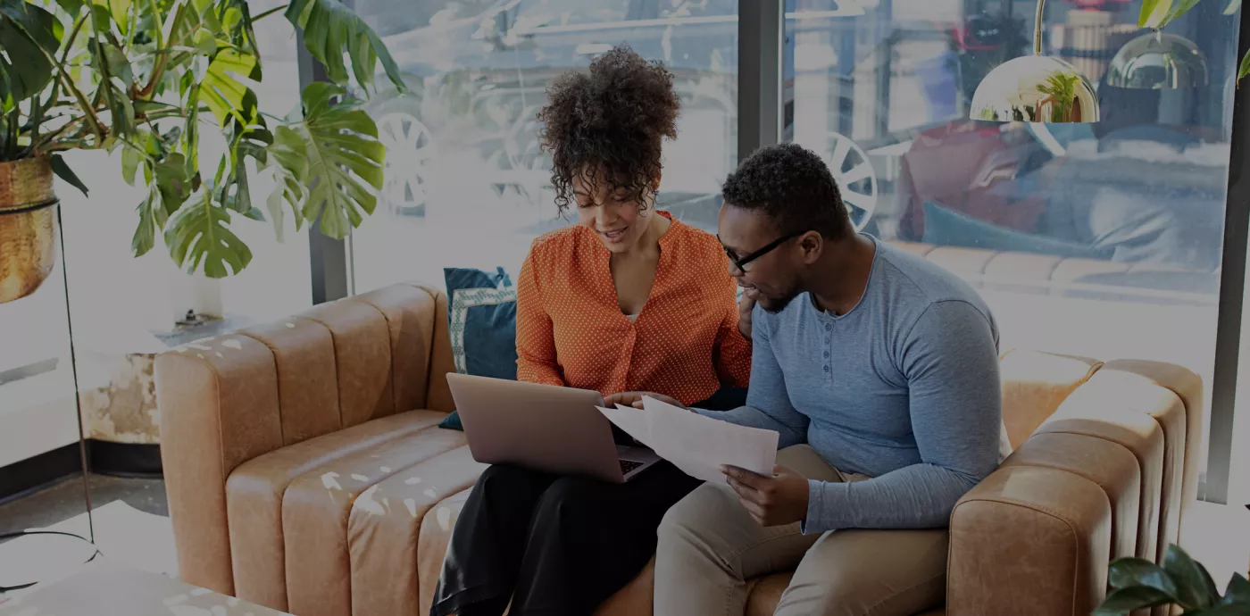 black couple on computer looking at personal loans